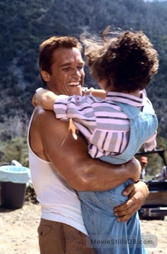 Commando - Publicity still of Arnold Schwarzenegger & Alyssa Milano